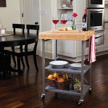 the folding cart with wine, dishes, and more on it