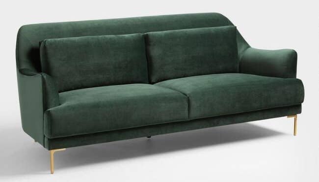 green velvet mid century modern style couch with cushions on the back