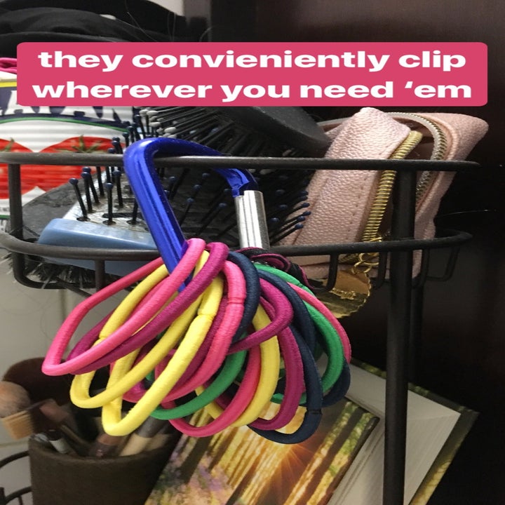 carabiner with ponytails on it, hanging from my wire storage shelf