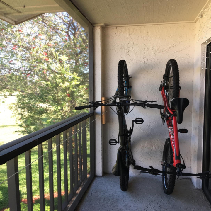 two reviewer's bikes stashed vertically on their balcony
