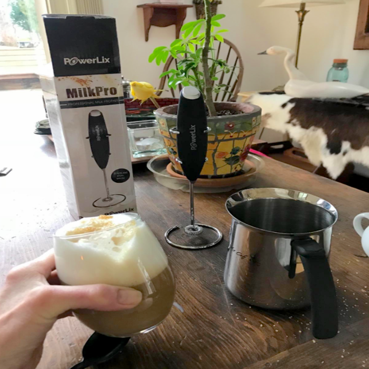 different review image of frothy coffee next to handheld mixer