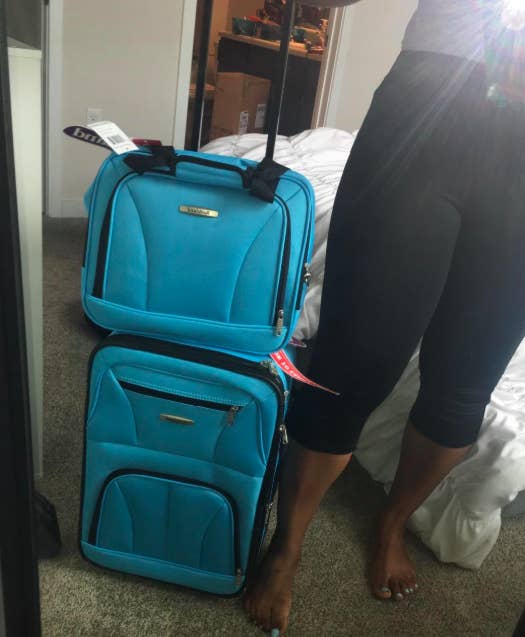 reviewer mirror selfie with the teal luggage set