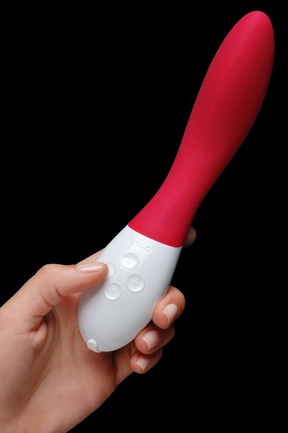 hand holding a red and white oblong vibrator