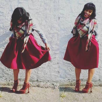 A different reviewer wearing the skirt in red with a scarf and booties