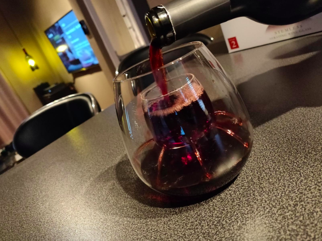 Wine being poured into aerating wineglass 