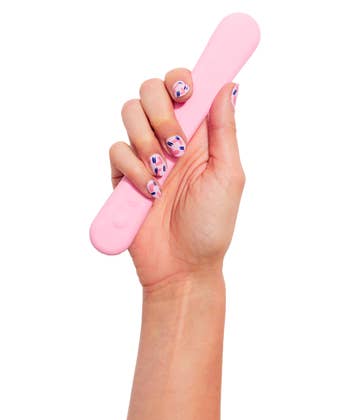 model hand with painted nails holding the Bender in pink