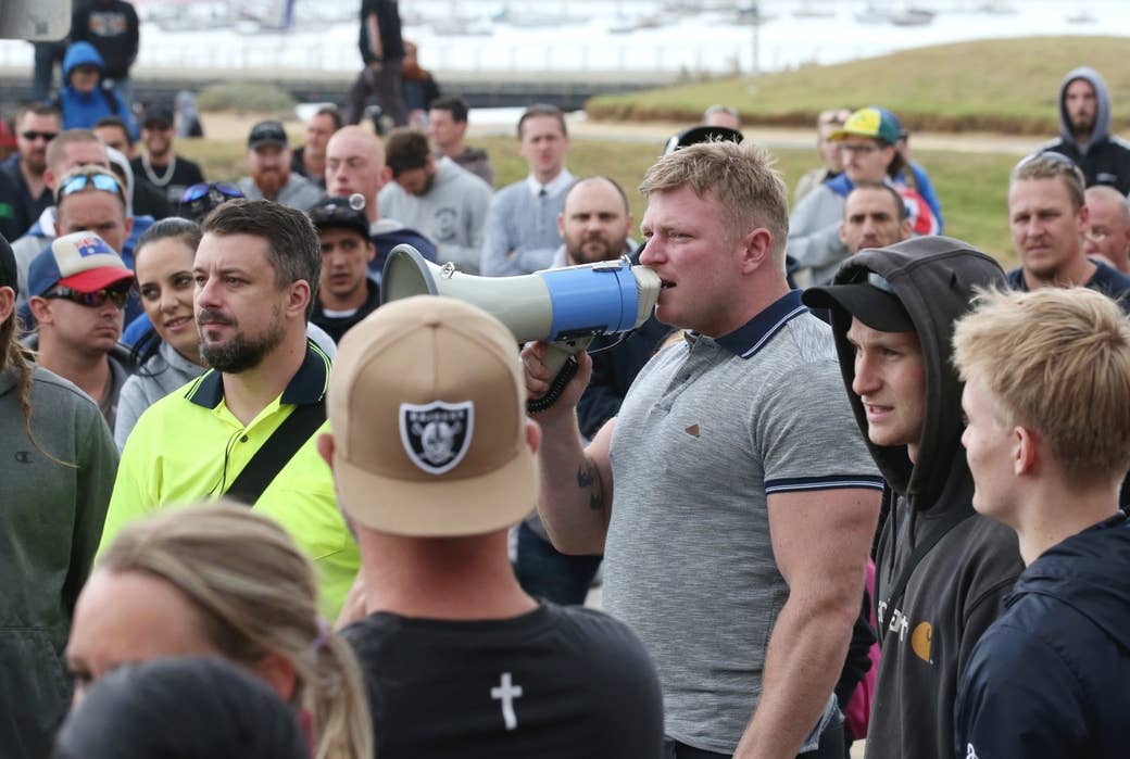 Far right wing activists Neil Erikson (yellow shirt) and Blair Cottrell (3rd right) are seen on St Kilda foreshore in Melbourne, Saturday, January 5, 2019.