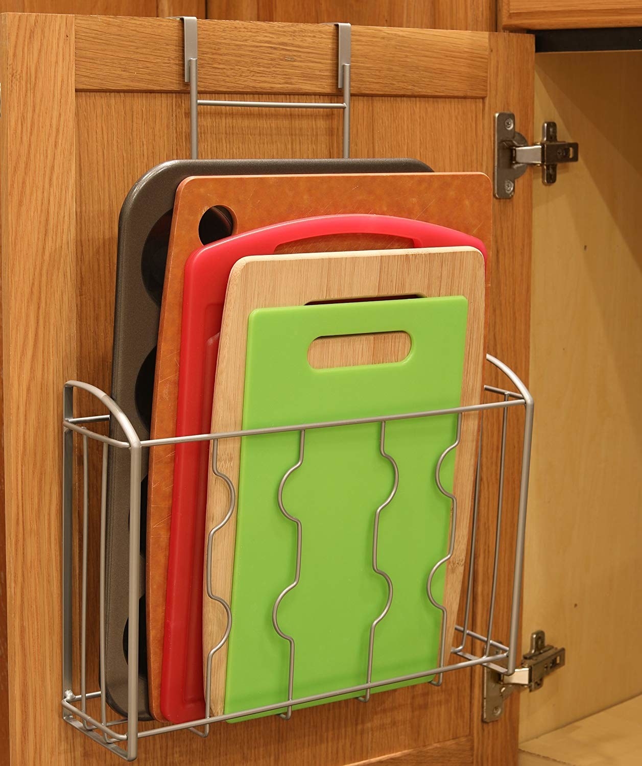 Promising review: "This organizer is so useful! I recently moved and ended up with a much smaller kitchen, so I've been doing everything I can to make sure there's a place for everything and no wasted space. Luckily, I have pretty wide cabinets, so this works out perfectly. I have one holding my cutting boards (four standard plastic boards) and another holding my foil, cling wrap, and parchment paper boxes. The organizer is super easy to assemble and it's completely versatile — you can hang it over the cabinet door or attach it to the wall/cabinet door, which means it's great for renters and owners." —KerryGet it from Amazon for $13.97.