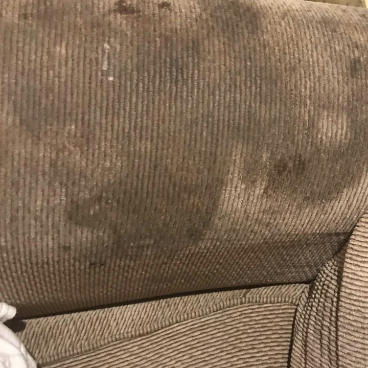 a couch rest with unsightly deep stains