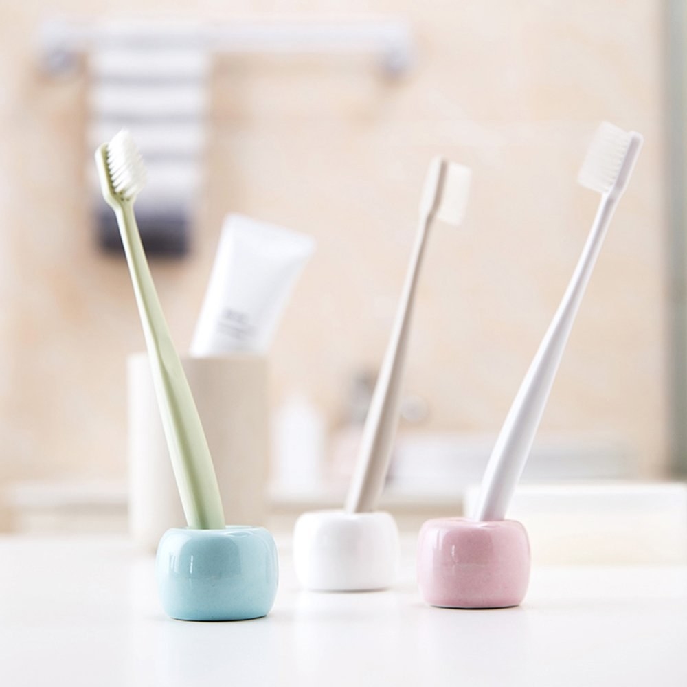 the rounded small toothbrush holders in pastel blue, pink, and white
