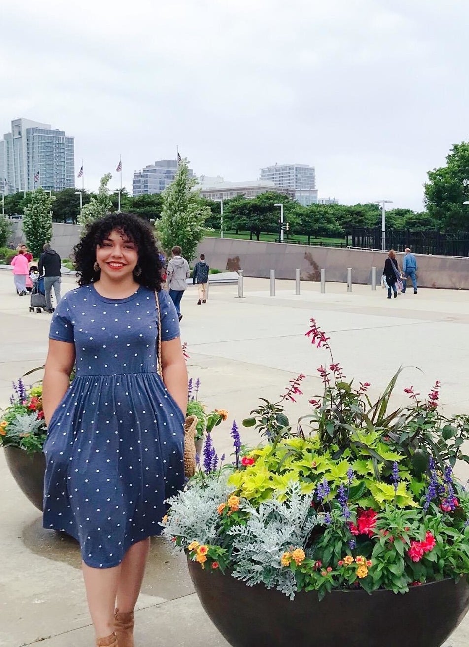 reviewer wears dress with white polka dot 