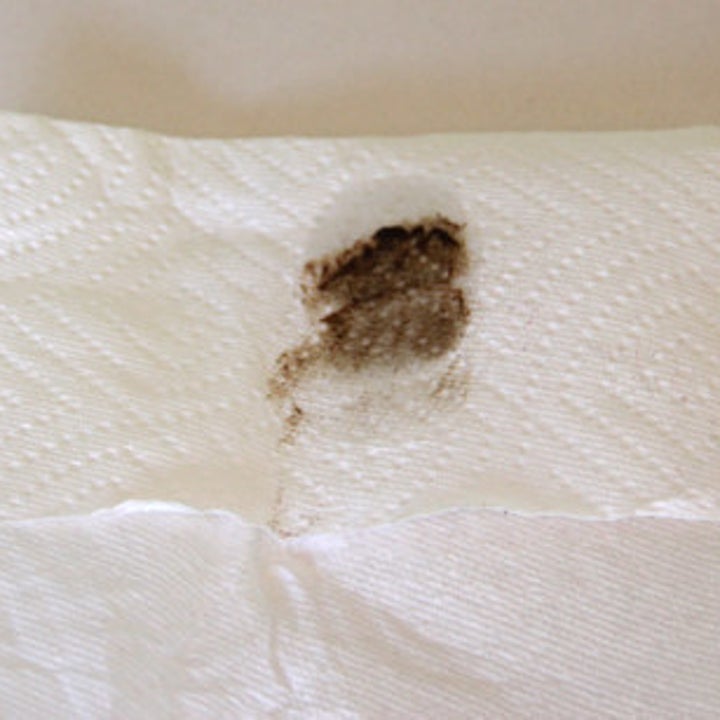 A paper towel with mineral oil and two fingerprints of the gross sticky dust that came up