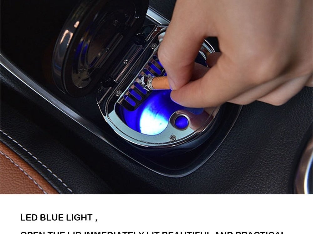 person putting their cigarette out in a light-up ash tray that fits in a car cup holder