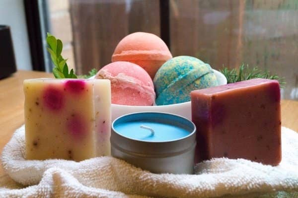 three bath bombs, two soap bars, and a candle 