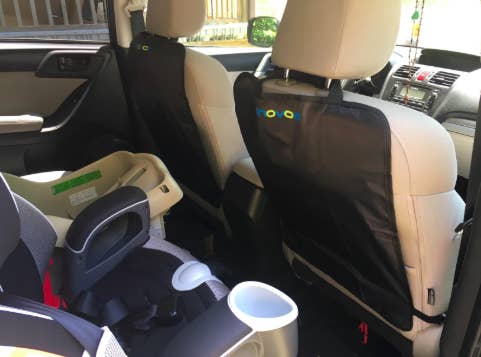 reviewer's car with the kicking protector on the back of the car seat