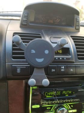 the person-shaped phone holder attached to a car vent