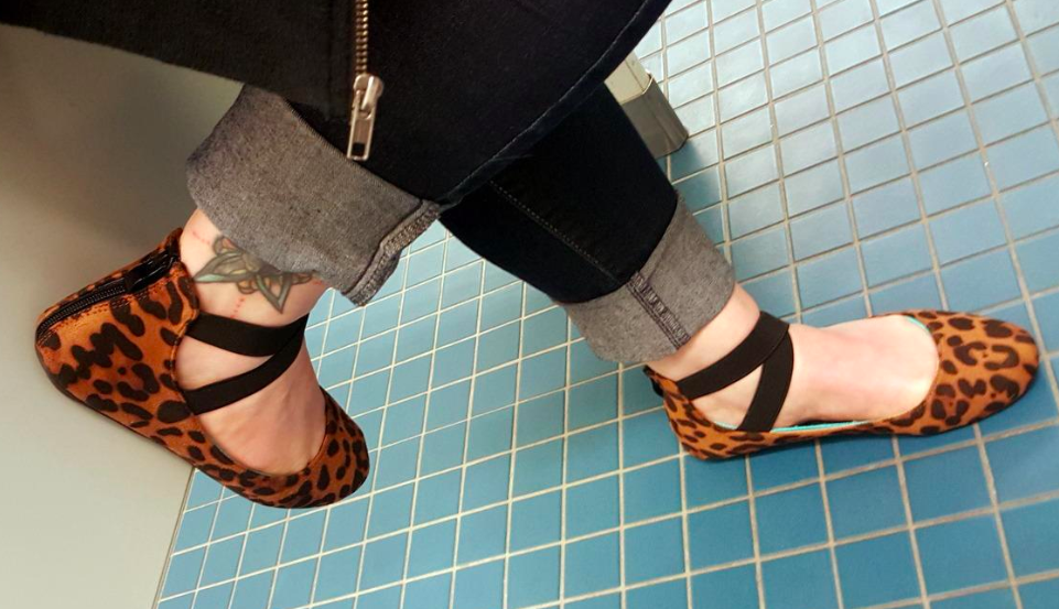 A customer review photo of a person wearing the ballerina flats in leopard print. 