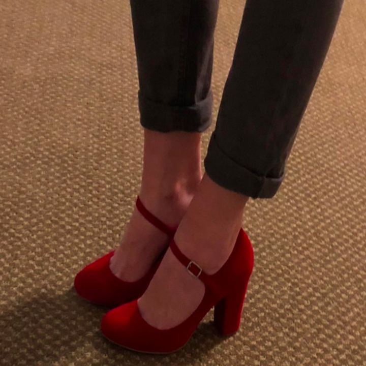 A customer review photo of a person wearing the Mary Jane heels in red