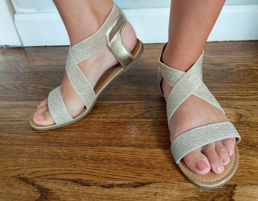 A customer review photo of a person wearing the ankle-strap sandals