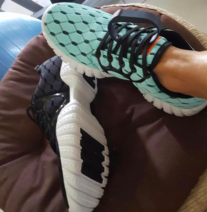 A customer review photo of a person wearing the mesh running sneakers in light blue