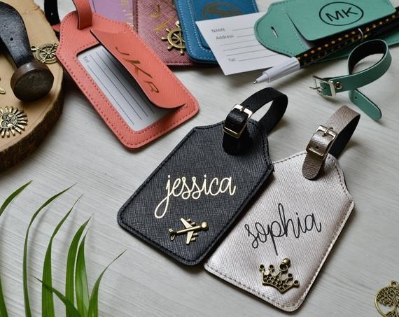 the personalized leather luggage tags with names and charms on them