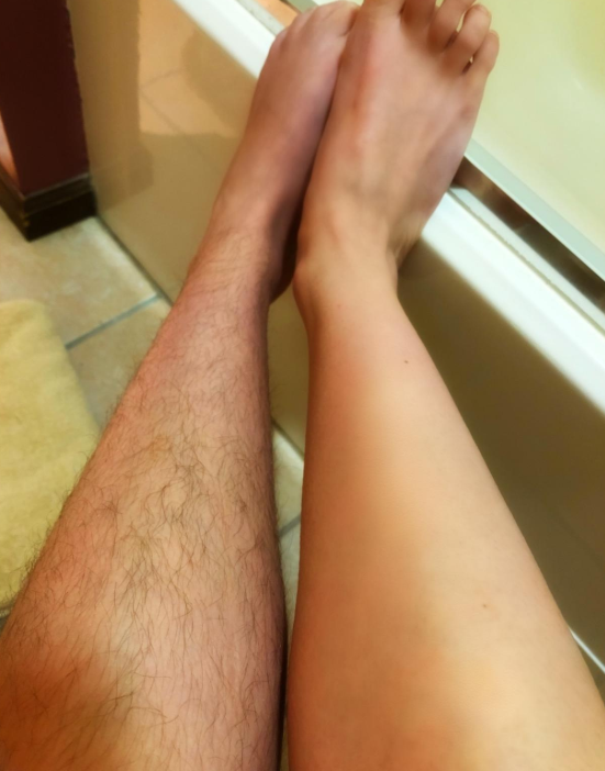 reviewer's smooth shaved leg next to a hairy leg that hasn't been shaved yet