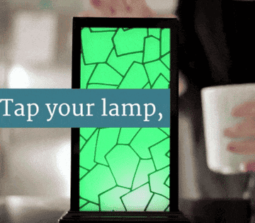 a gif of two people touching the lamps and the lamps changing color