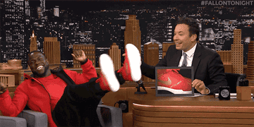 A gif of Kevin Hart tapping his feet together while on The Tonight Show with Jimmy Fallon. 