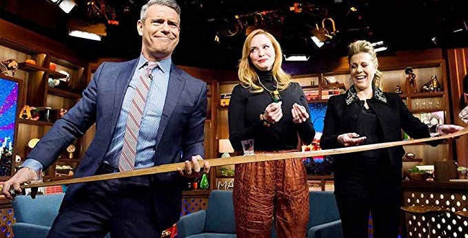 andy cohen holding a shotski