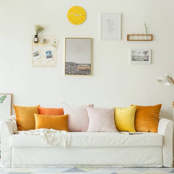 A variety of the velvet pillow covers on a sofa