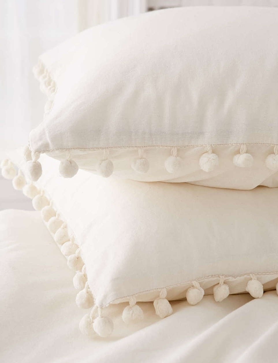 Two of the cotton shams on pillows stacked on top of each other