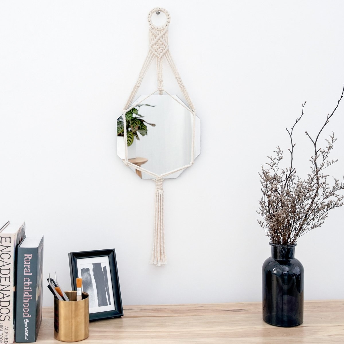 The macrame wall mirror hanging on a wall
