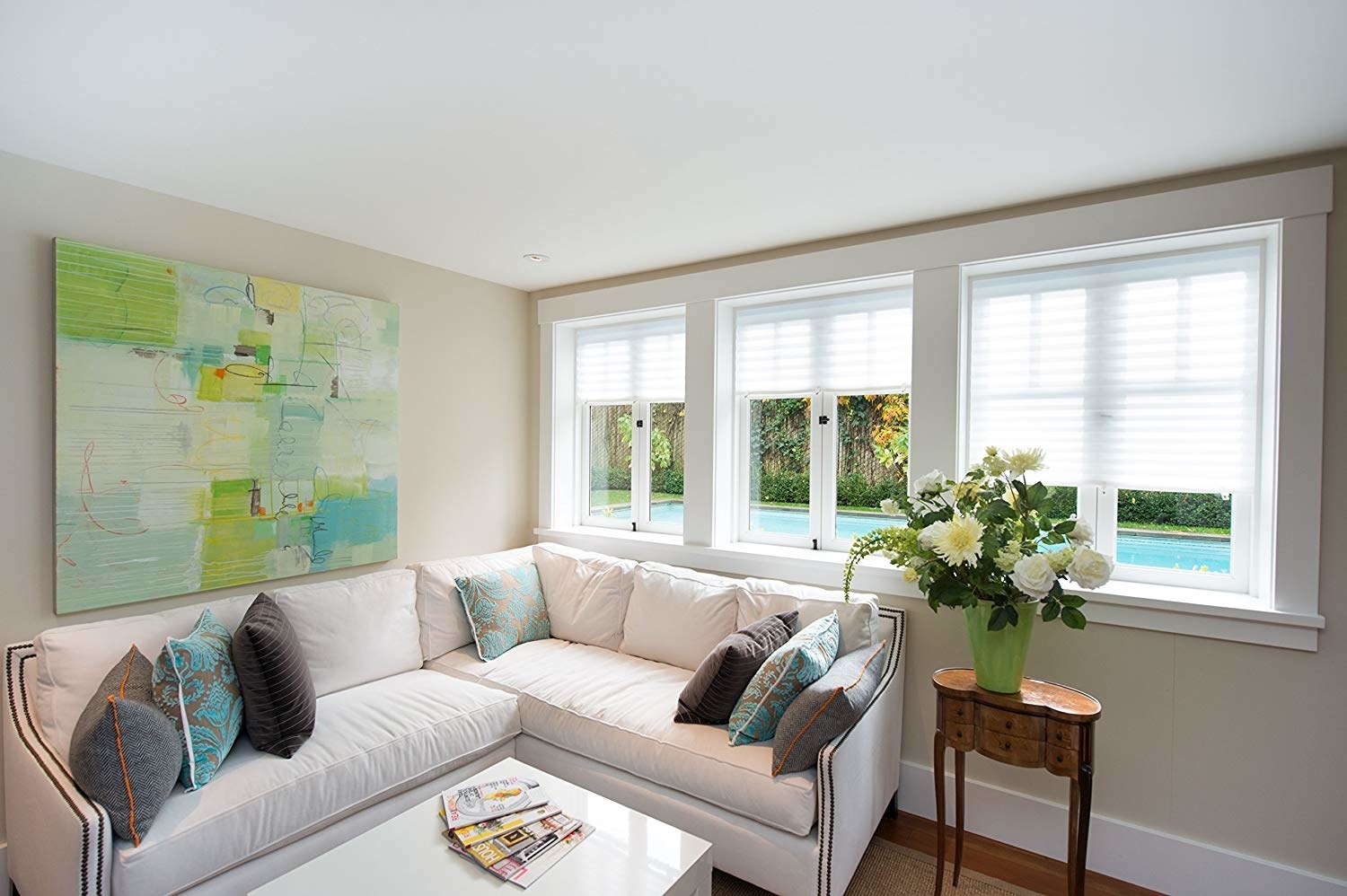 The pleated fabric shades installed on a few windows in a living room.