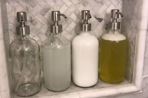 A customer review photo of four soap dispensers in their shower.  