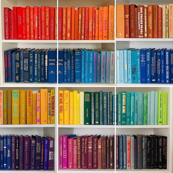 A bookshelf filled with color-coordinated books.