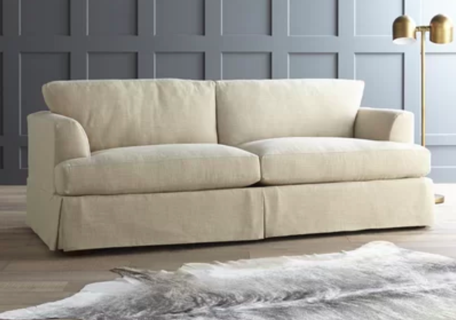 The cream-colored sofa placed in a room