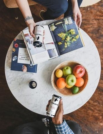 person holding a can of the coffee