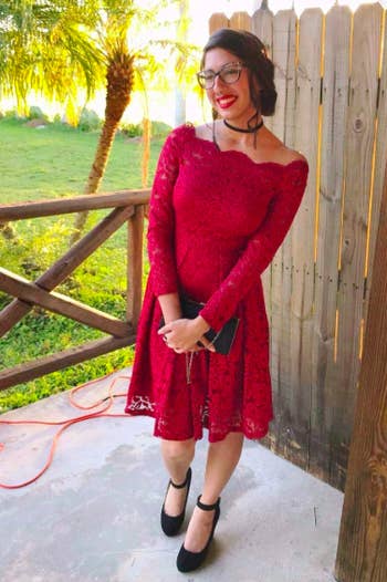 A reviewer wearing the boatneck fit and flare dress with long sleeves in red 