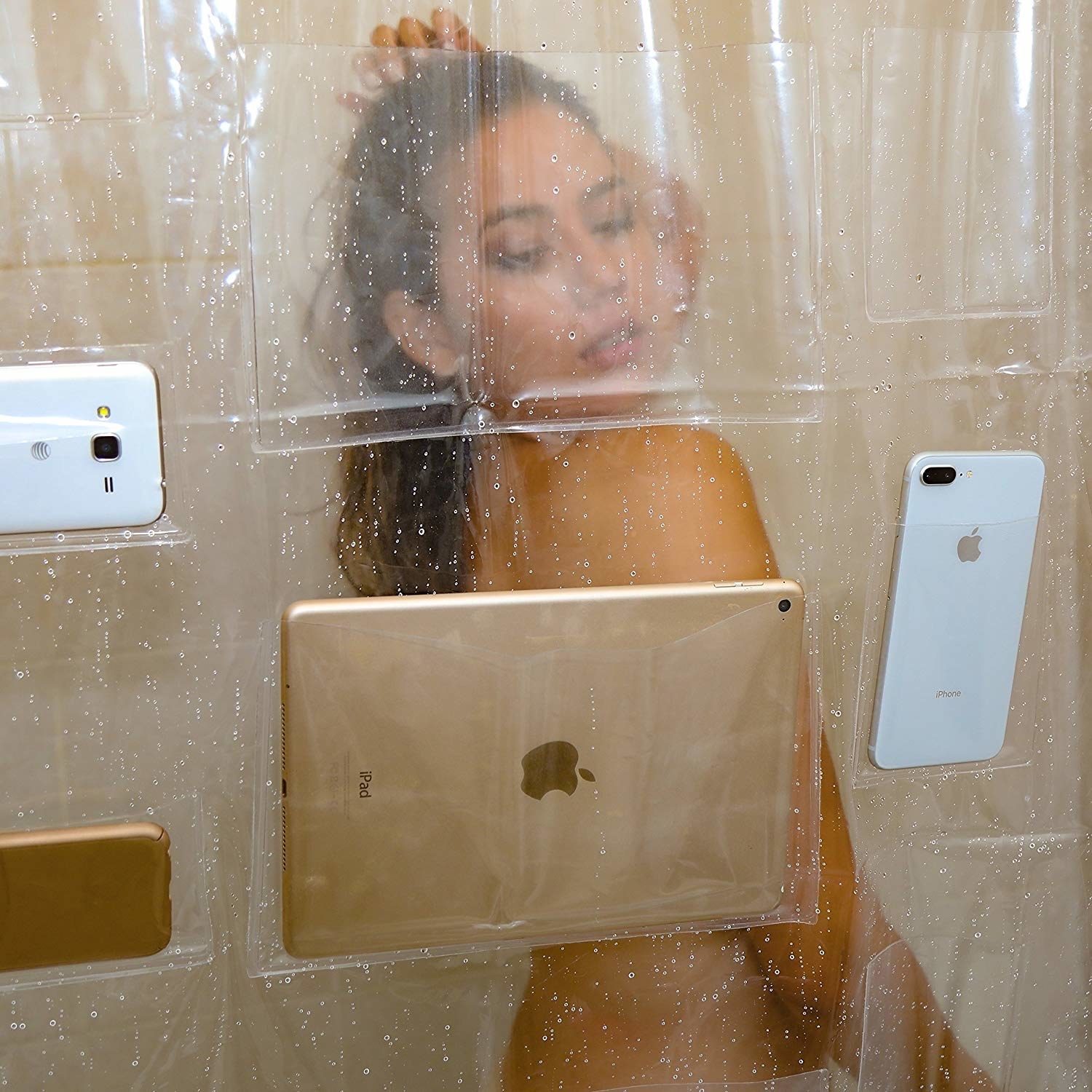devices in pockets of clear shower curtain