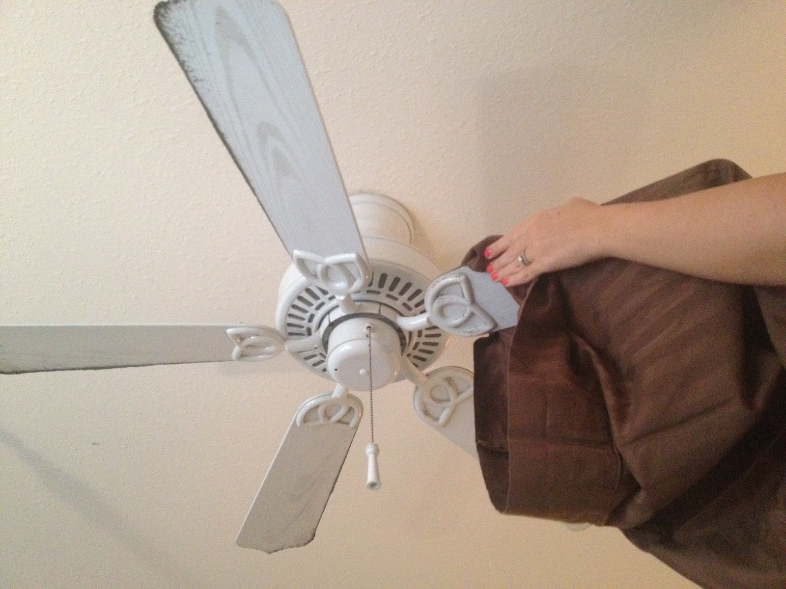Cleaning a ceiling fan with a pillow case