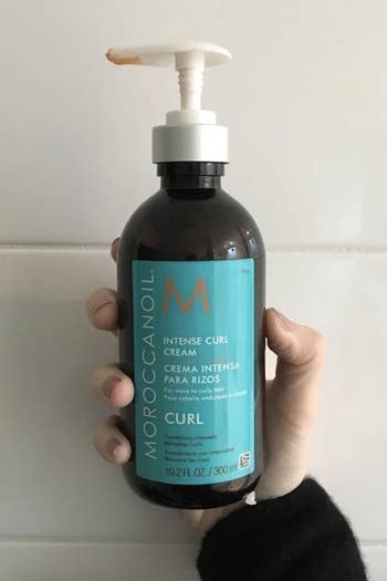 Hand holding Moroccan oil