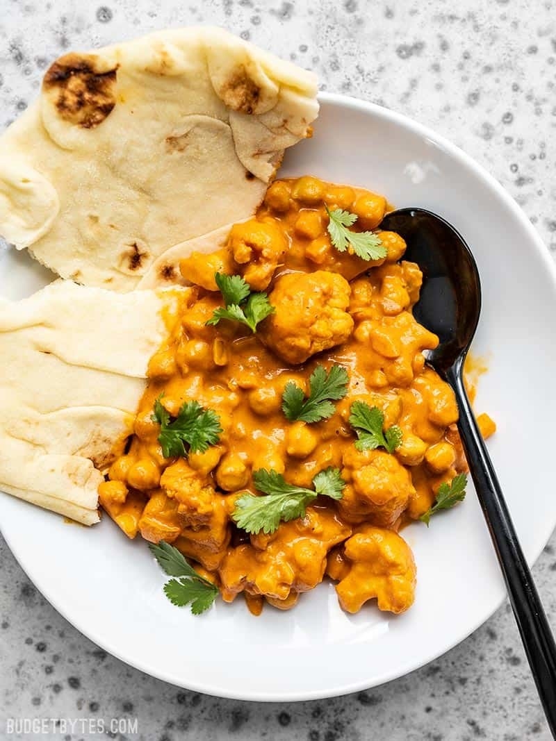 Cauliflower and Chickpea Masala with naan on a plate