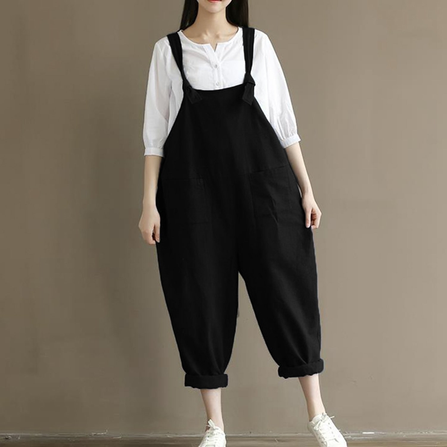 model shows how loose the overalls with cuffed bottoms