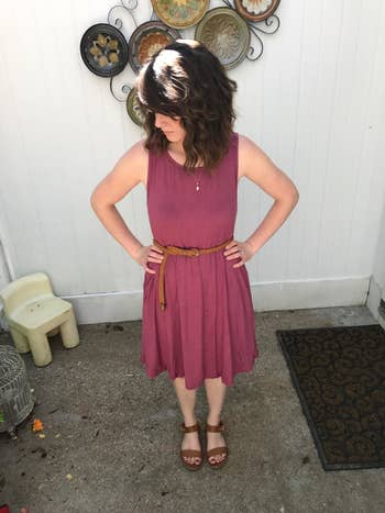 Reviewer wearing mauve tank dress with a belt and sandals