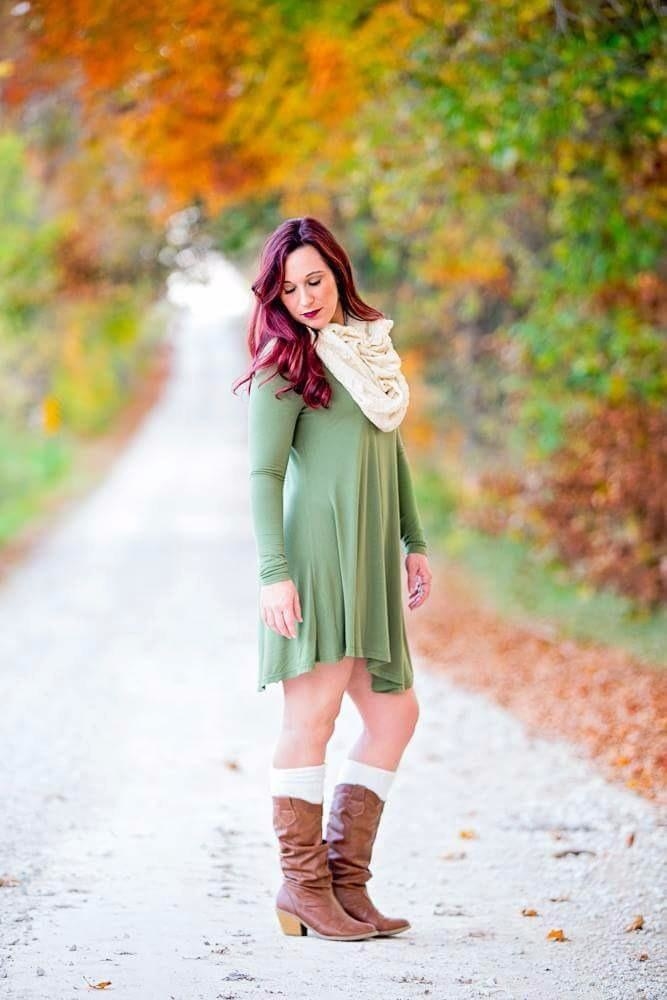 reviewer wearing the green dress with cowgirl boots and a scarf