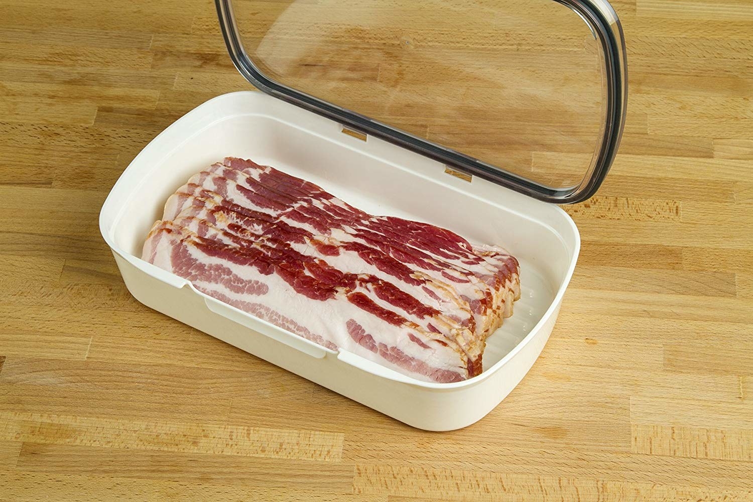 container with clear top open to reveal strips of raw bacon inside