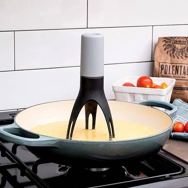 a tube-like gadget with three prongs at the bottom that sit inside a pan and stir for you