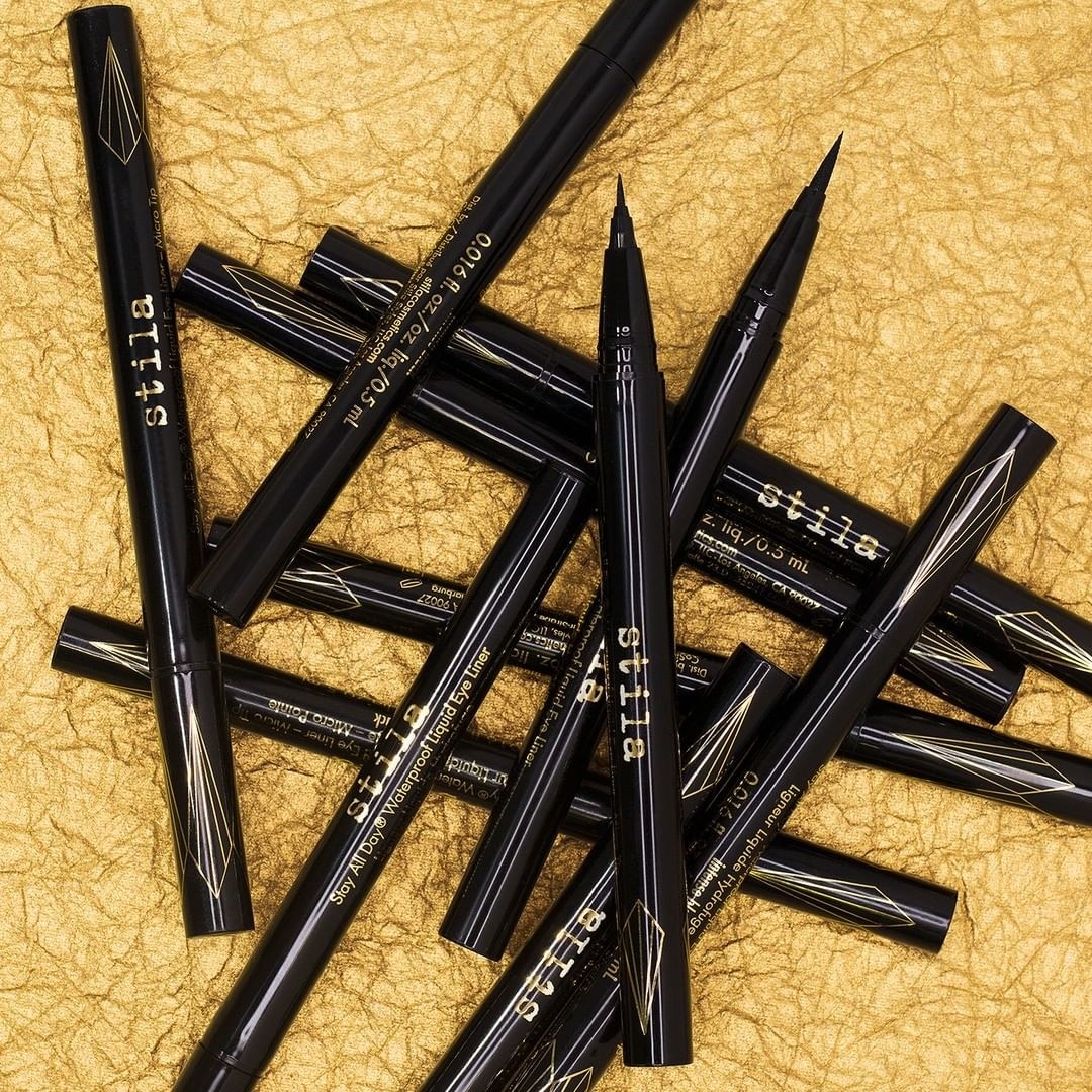 A collection of black eyeliner pens on top of each other