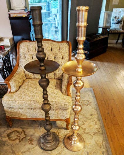 Two candle sticks side by side; one having been treated with the product and looking brand new and the other still rusted over 
