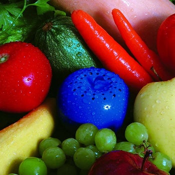 small blue apple-shaped freshener tucked among produce